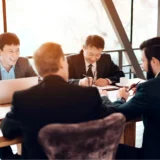 Senior executives discussing market entry strategy and business presence in a modern boardroom in Vietnam